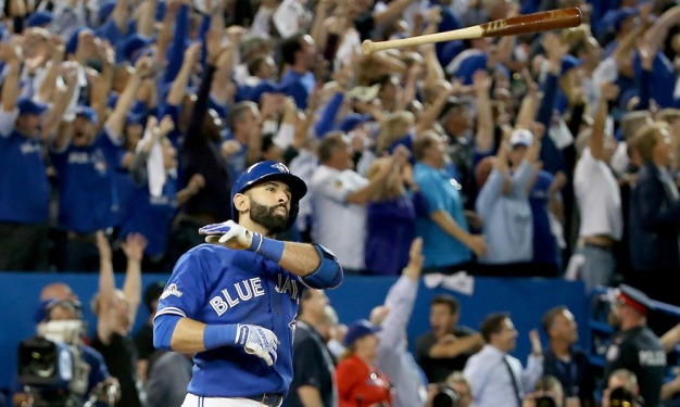 TORONTO, ON - OCTOBER 14: Jose Bautista #19 of the Toronto Blue Jays throws his bat up in the air after he hits a three-run home run in the seventh inning against the Texas Rangers in game five of the American League Division Series at Rogers Centre on October 14, 2015 in Toronto, Canada. (Photo by Tom Szczerbowski/Getty Images) ORG XMIT: 583944595 ORIG FILE ID: 492684094